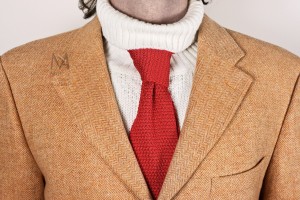 Unconventional elegance A silk necktie improperly worn over a turtleneck sweater.