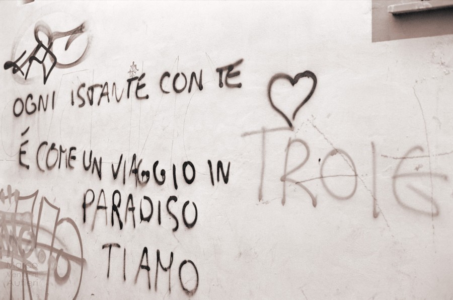In Italian, this graffiti on a wall reads as: "Each moment with you is like a journey to paradise, I love you", and "Whores". :-) Neopan 400 CN
