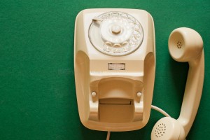 This telephone model was used in Italian homes a few decades ago. Large depth of focus. Green paper (textured) background.